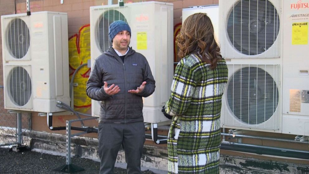 PHOTO: NYCHA program manager Jordan Bonomo speaks with Ginger Zee of ABC News about the heat pumps being used as part of the pilot program taking place at the Fort Independence Houses in the Bronx borough of New York.