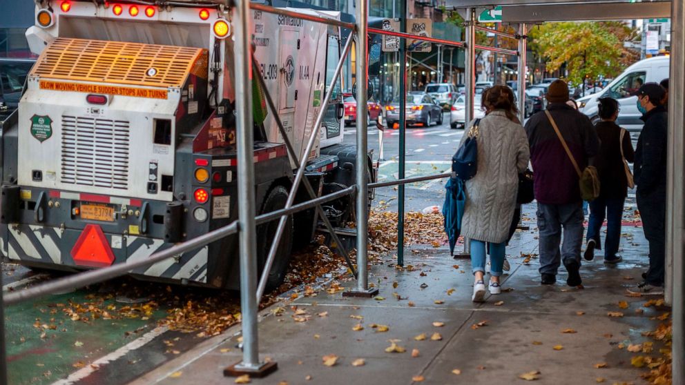 PHOTO: A NYC Dept. of Sanitation street sweeper gathers up fall foliage in the Chelsea neighborhood of New York City, Nov. 13, 2021/