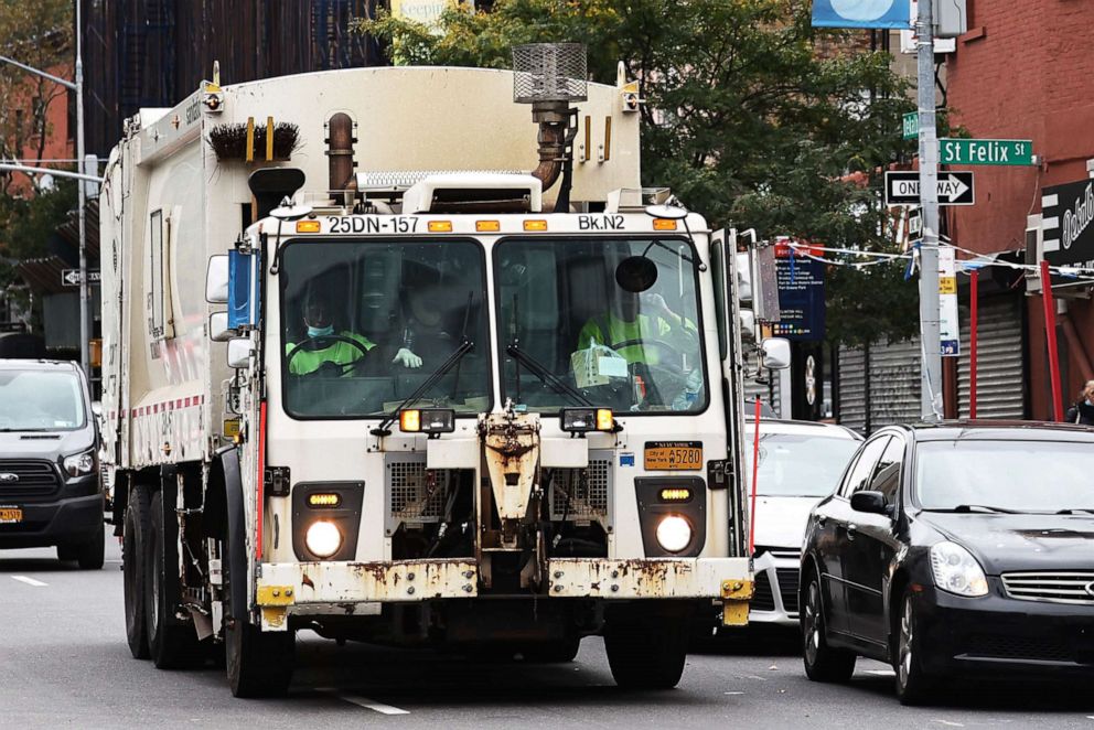 PHOTO: An NYC Sanitation truck drives down a street in Brooklyn, N.Y., Oct. 29, 2021.
