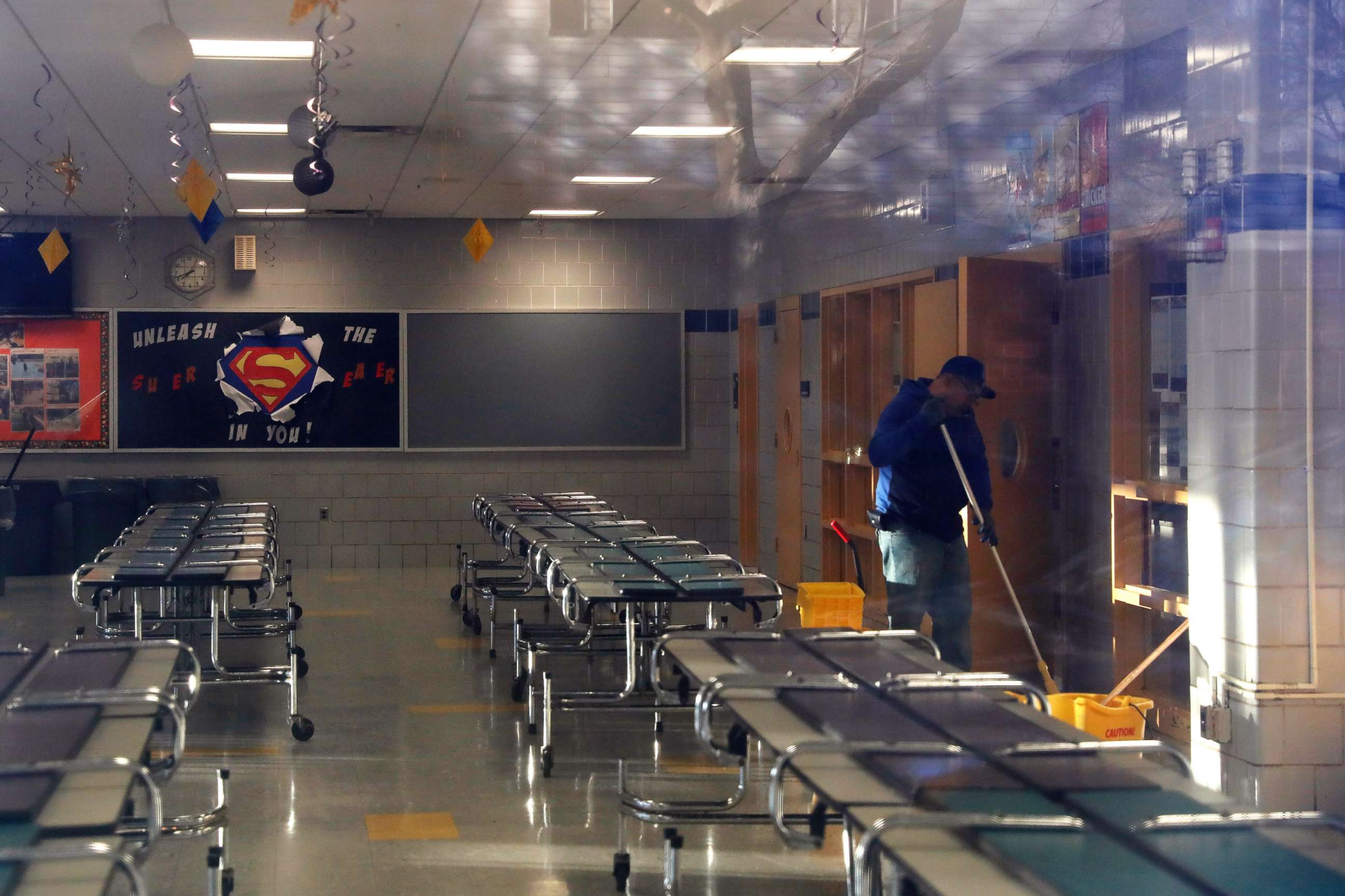 PHOTO: A man cleans the cafeteria of  P.S. 156 and L.S. 392, as the New York City school system canceled classes after further cases of coronavirus were confirmed in New York, March 16, 2020.