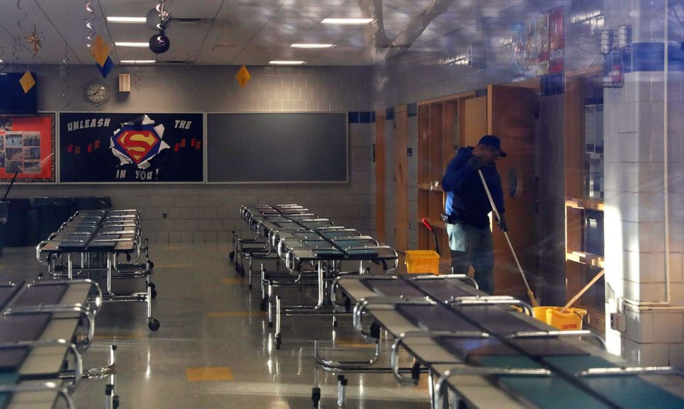 PHOTO: A man cleans the cafeteria of P.S. 156 and L.S. 392, as the New York City school system canceled classes after further cases of coronavirus were confirmed in New York, March 16, 2020.