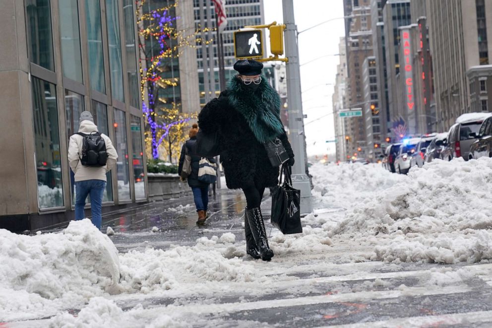 PHOTO: People slowly make their way through a snowy and slippery midtown Manhattan, Feb. 2, 2021.