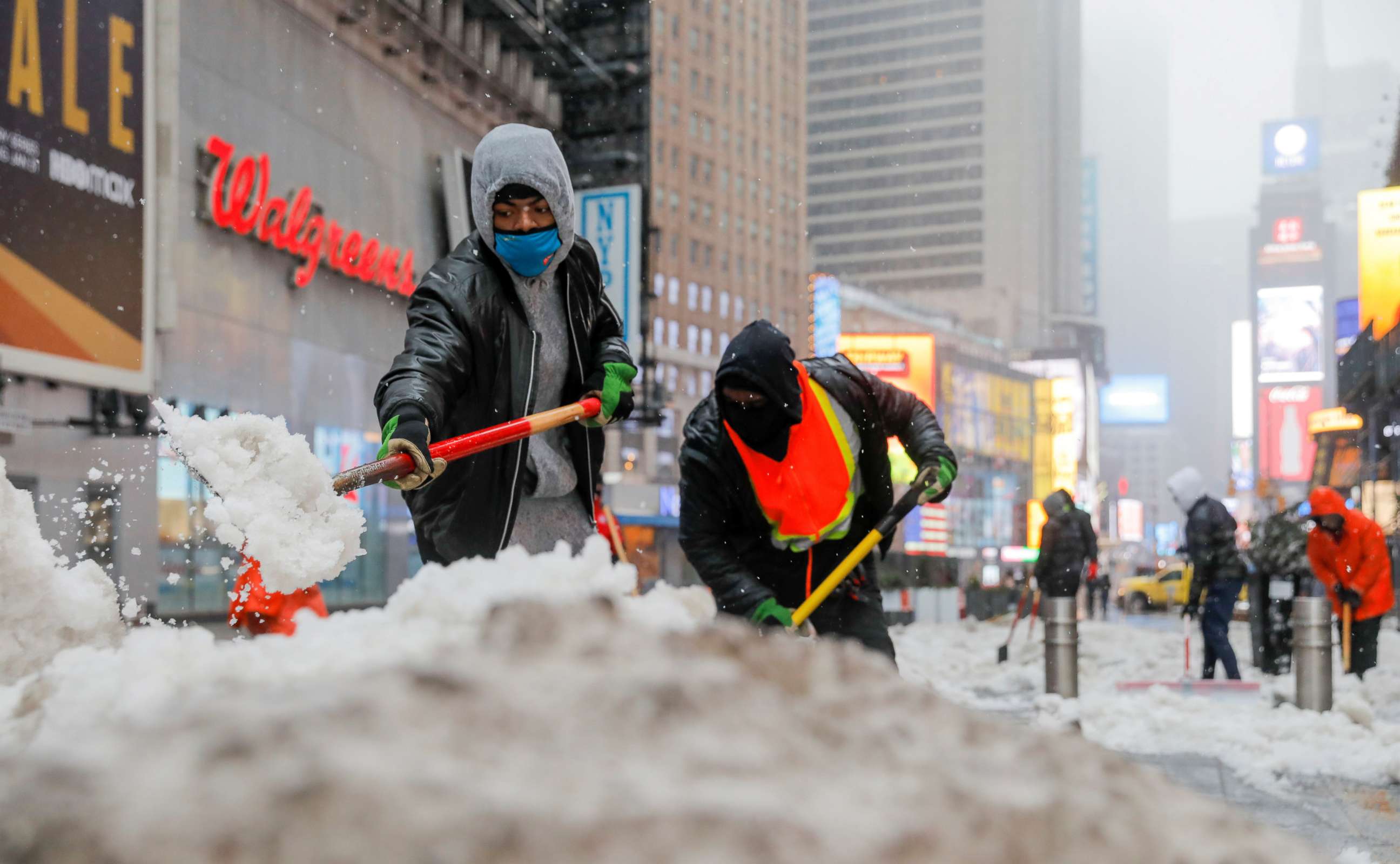 PHOTO: Workers shovel snow in Times Square as more severe weather arrives in Manhattan, Feb. 7, 2021.
