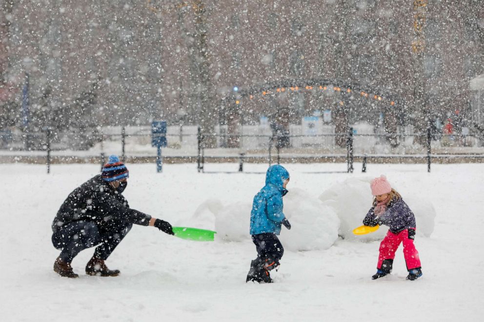 PHOTO: People play in the Stuy Town housing complex as snow falls in New York City, Feb. 7, 2021.
