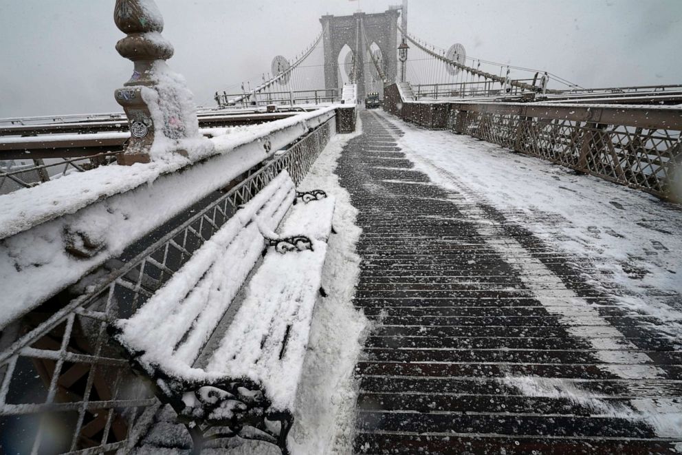 PHOTO: A snowplow clears the wooden pedestrian walkway on the Brooklyn Bridge, Feb. 7, 2021, in New York.