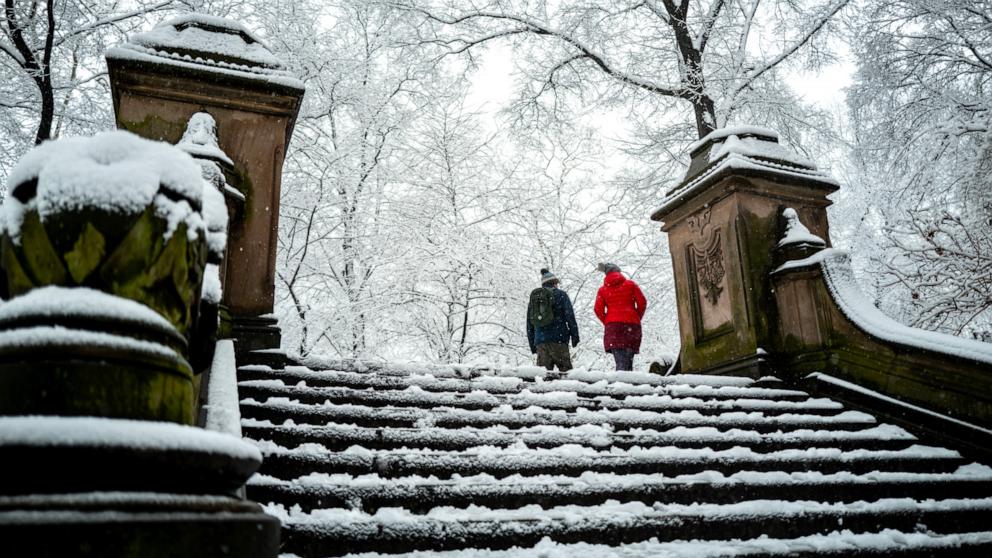 PHOTO: People walk through Central Park during a snowfall in New York City, Feb. 13, 2024.