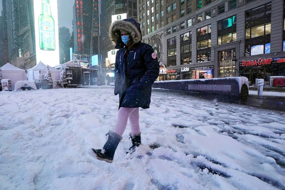 PHOTO: A girls kicks at snow in New York's Times Square, Jan. 7, 2022. 
