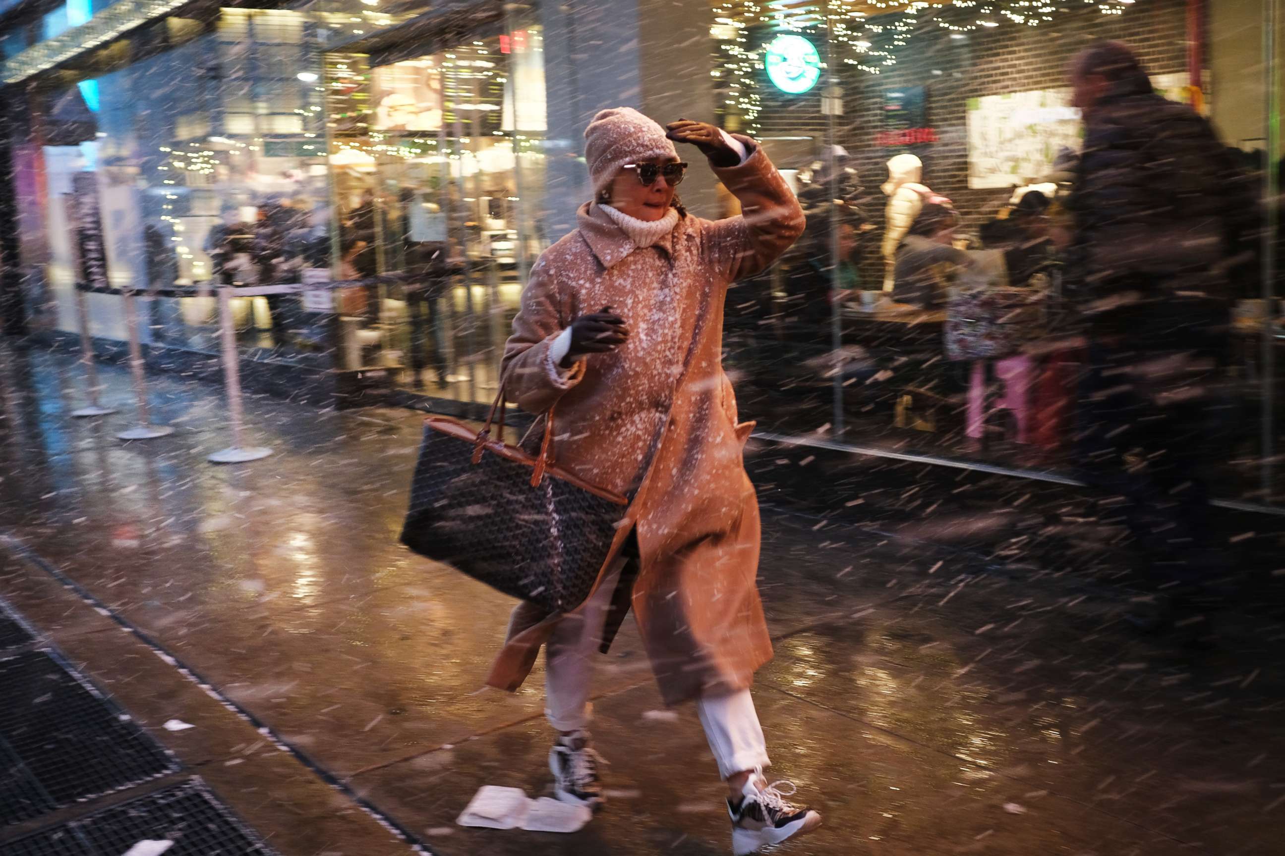 PHOTO: A woman walks through a snow squall in midtown Manhattan on Dec. 18, 2019, in New York.