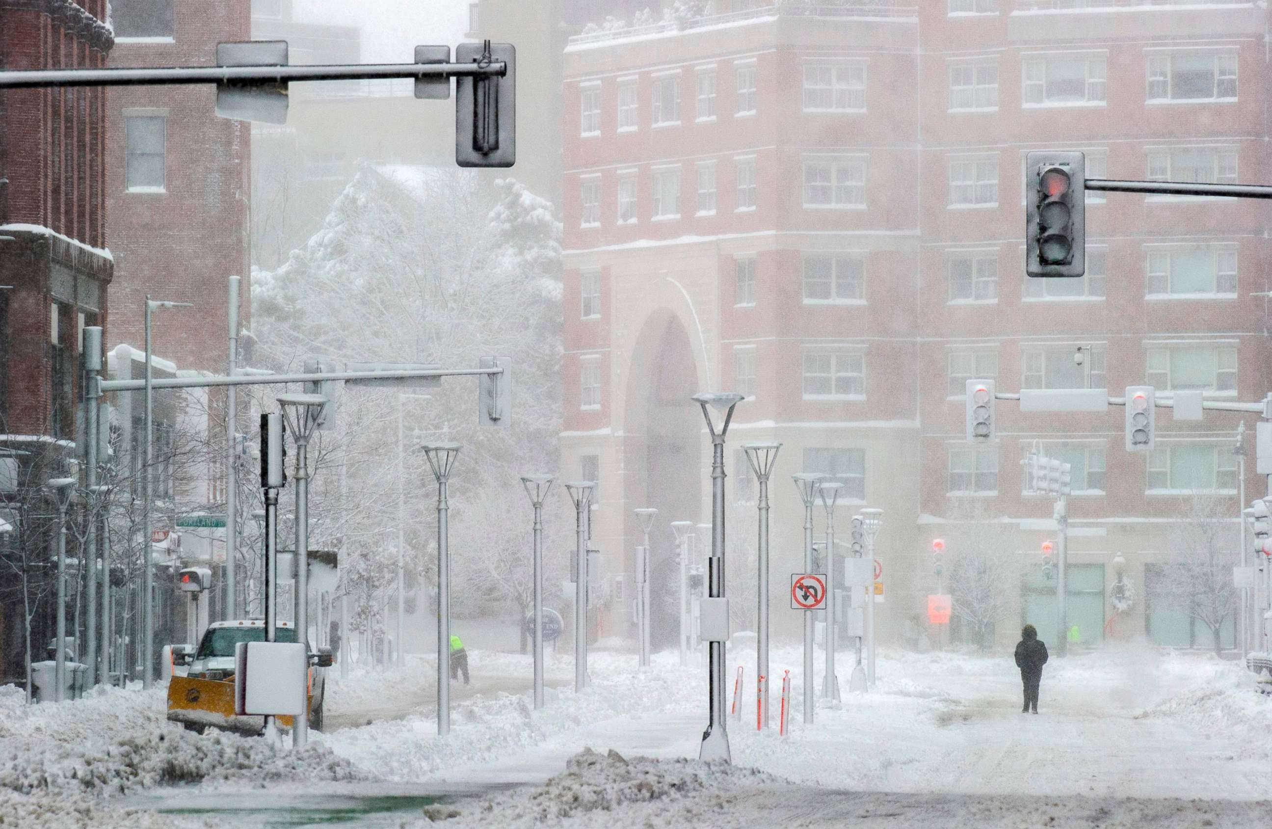 PHOTO: TOPSHOT - People walk in the snow in Boston, Massachusetts, on Dec. 17, 2020.