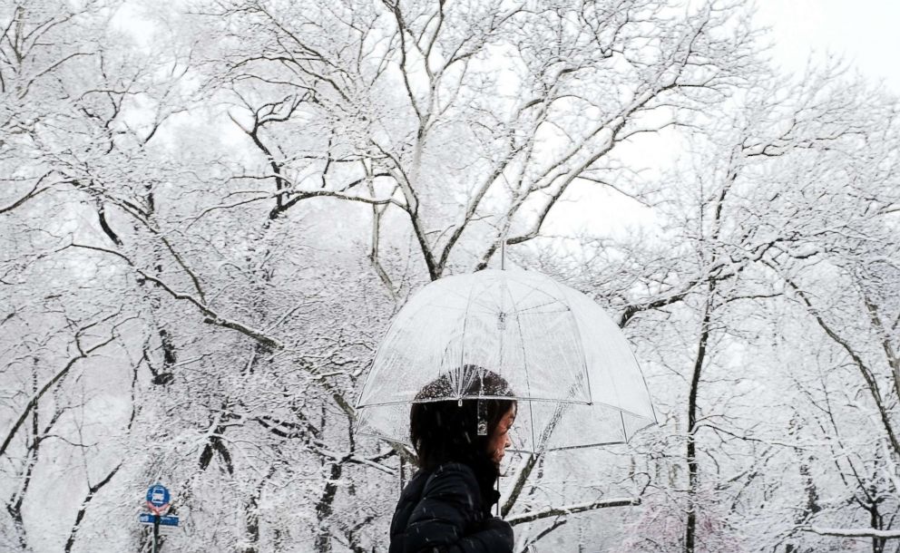 PHOTO: A pedestrian walks in the morning snow during an early spring storm on April 2, 2018 in New York City.