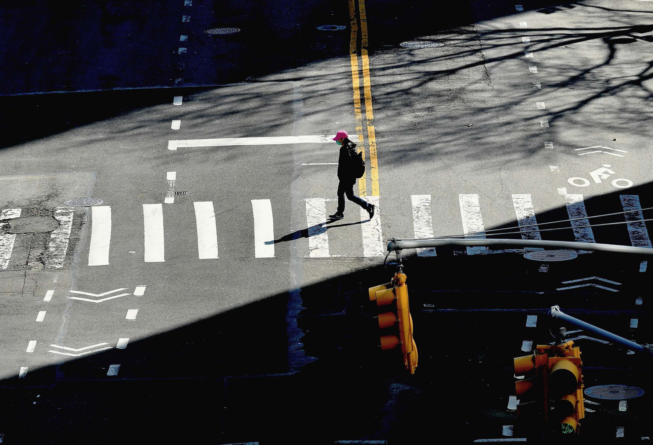PHOTO: A person crosses the street on March 27, 2020 in New York City.