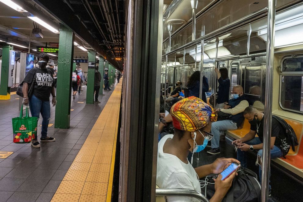 PHOTO: People ride the subway at Times Square during rush hour on the first day of phase one of the reopening after the coronavirus lockdown, June 8, 2020, in New York City.