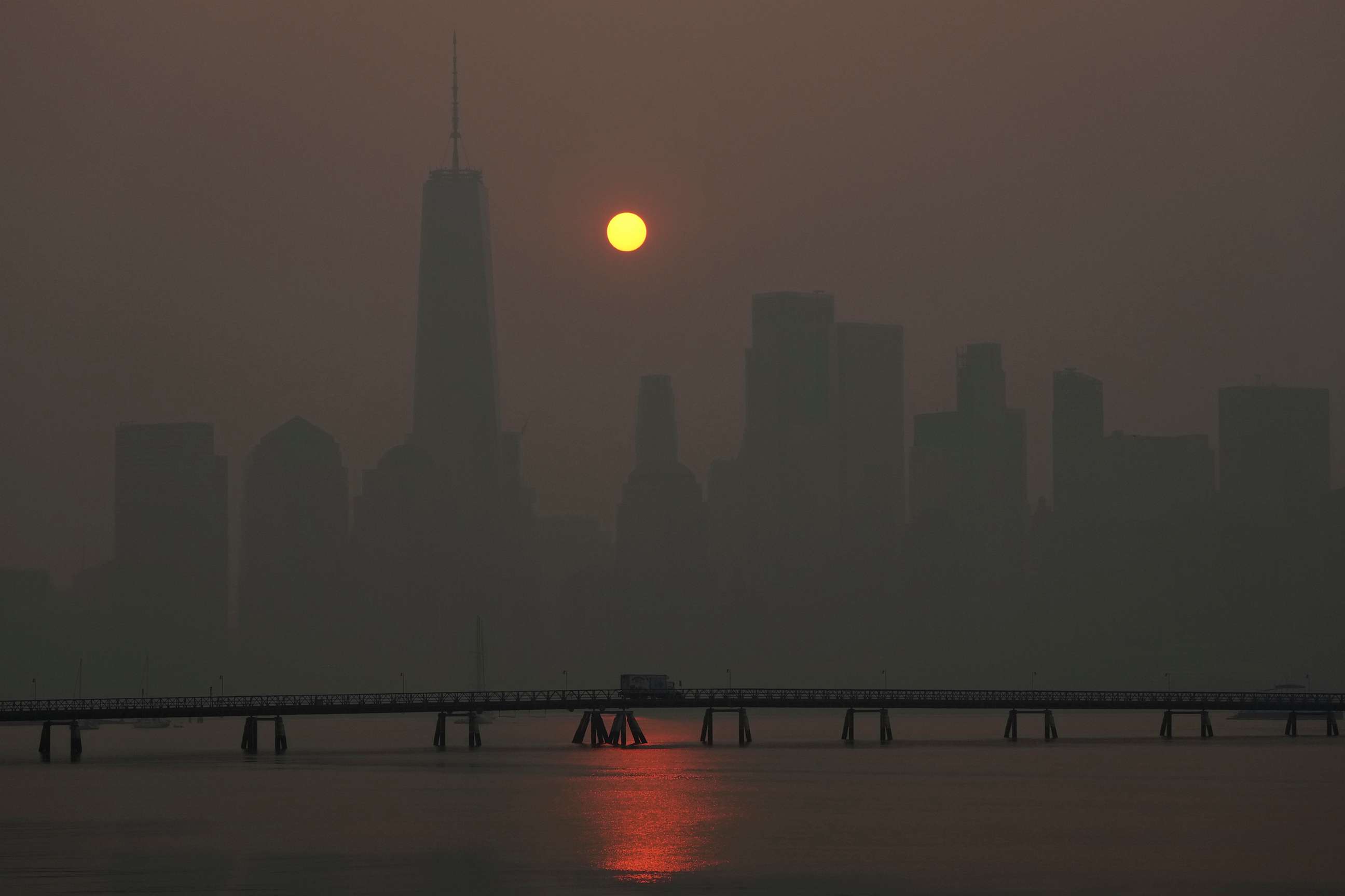 PHOTO: The sun rises over the lower Manhattan skyline as seen from Jersey City, N.J., June 8, 2023.