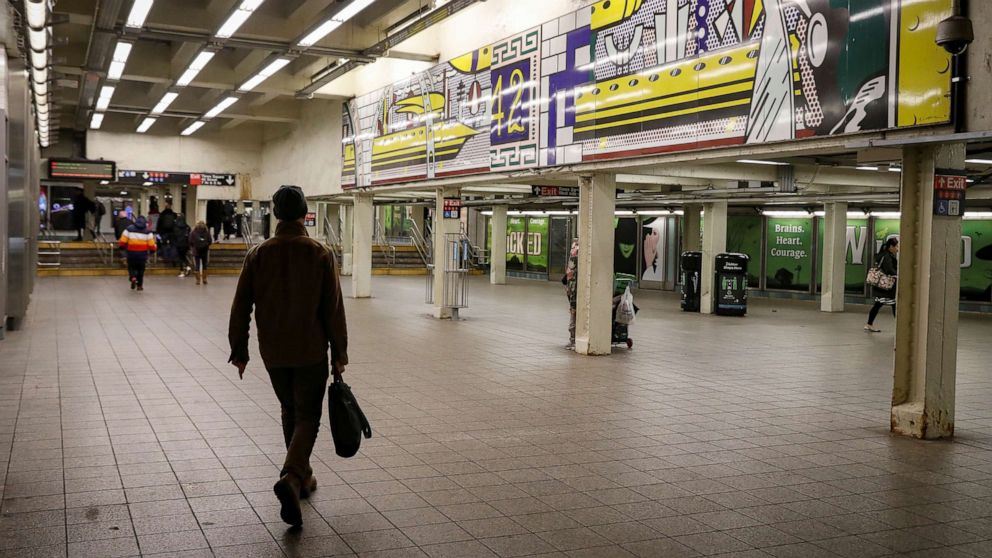 PHOTO: A man walks through a nearly empty Times Square - 42nd St. subway station during the morning rush in New York City, March 16, 2020.