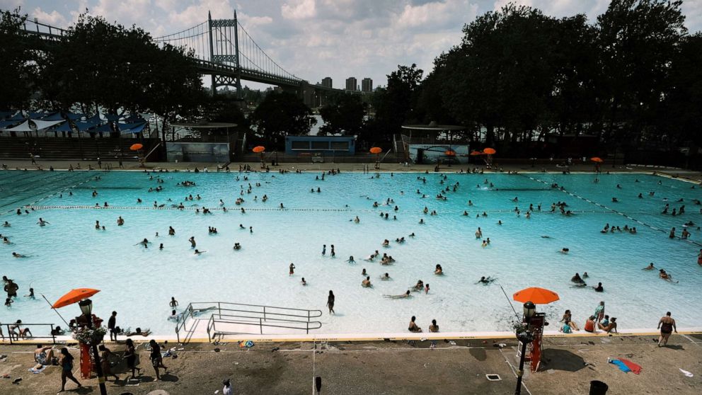 PHOTO: People cool off in a public swimming pool on June 29, 2021 in the Astoria neighborhood of the Queens borough in New York City.