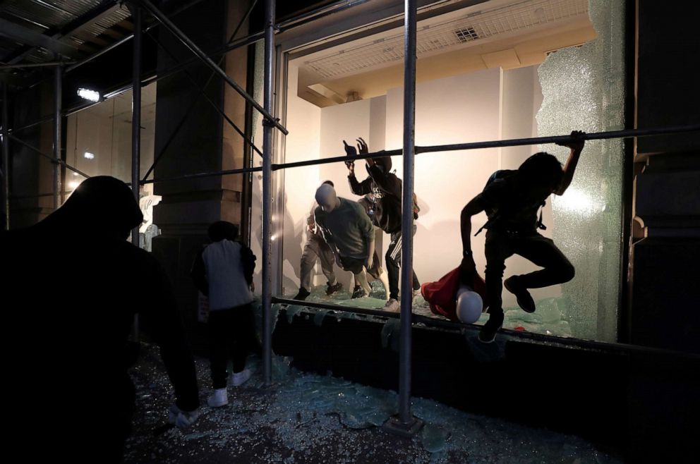 PHOTO: A man jumps from the window of a damaged store in New York City, June 2, 2020.