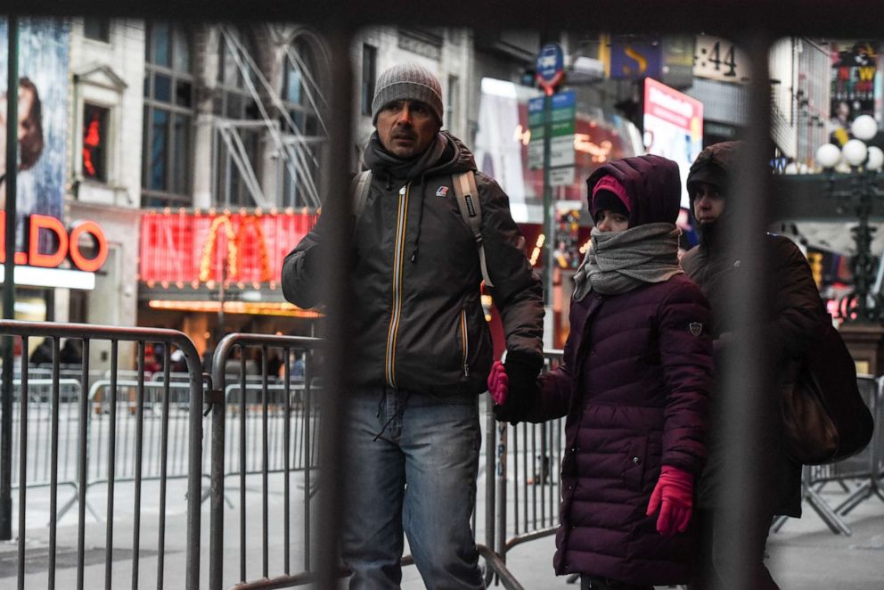 PHOTO: Pedestrians navigate the security barriers in Times Square ahead of the New Year's Eve celebration on Dec. 31, 2017, in New York.