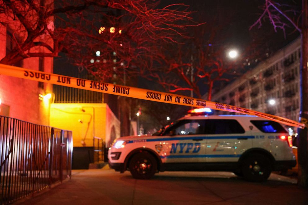 PHOTO: Crime scene units are seen on a closed portion of 135th Street, as members of the New York City Police Department investigate the scene where two officers were shot responding to a domestic violence call in Harlem, N.Y., Jan. 21, 2022.