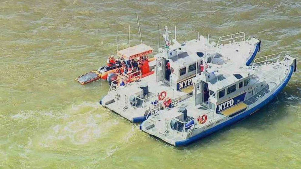 PHOTO: U.S. Coast Guard and New York Police Department personnel search for a missing swimmer from a competition on Friday, June 14, 2019.