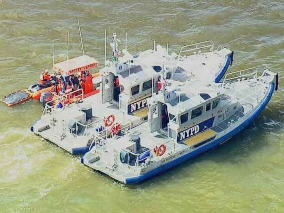 PHOTO: U.S. Coast Guard and New York Police Department personnel search for a missing swimmer from a competition on Friday, June 14, 2019.
