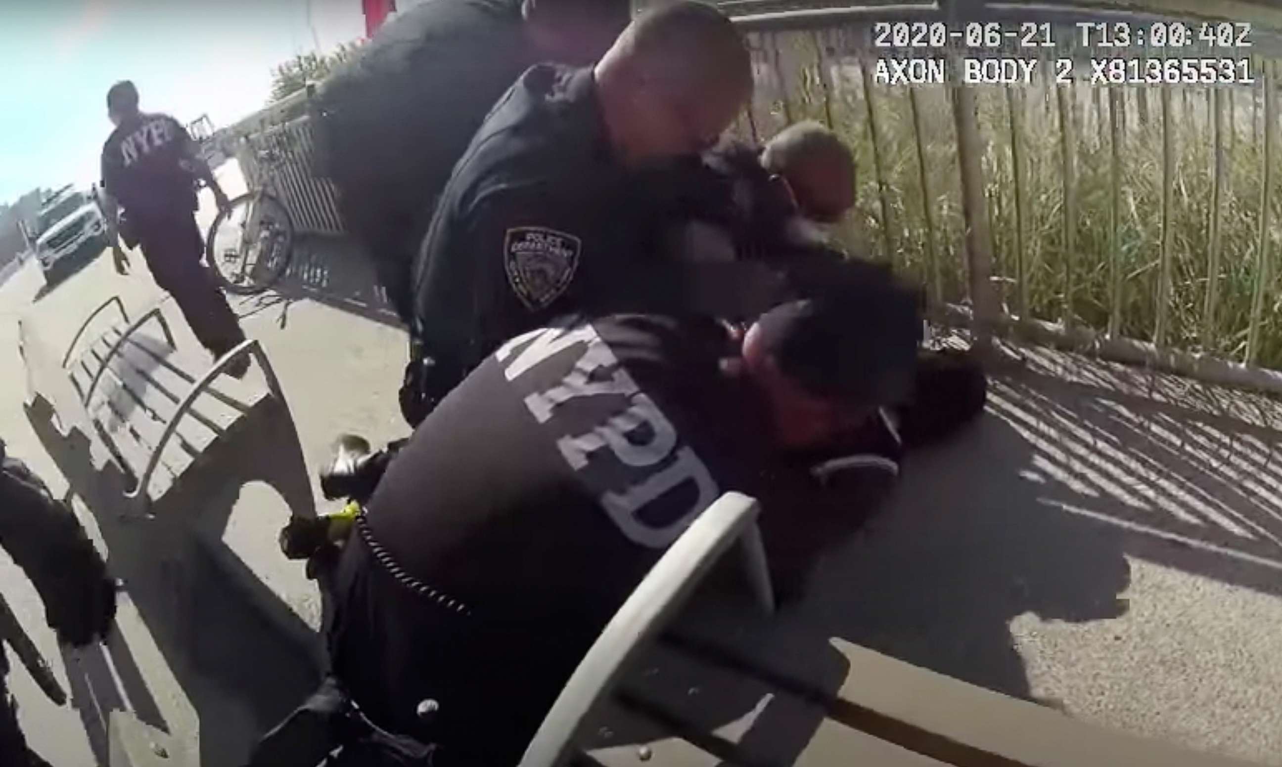 PHOTO: In this photo taken from video, New York Police officers arrest a man on a boardwalk, June 21, 2020, in New York.
