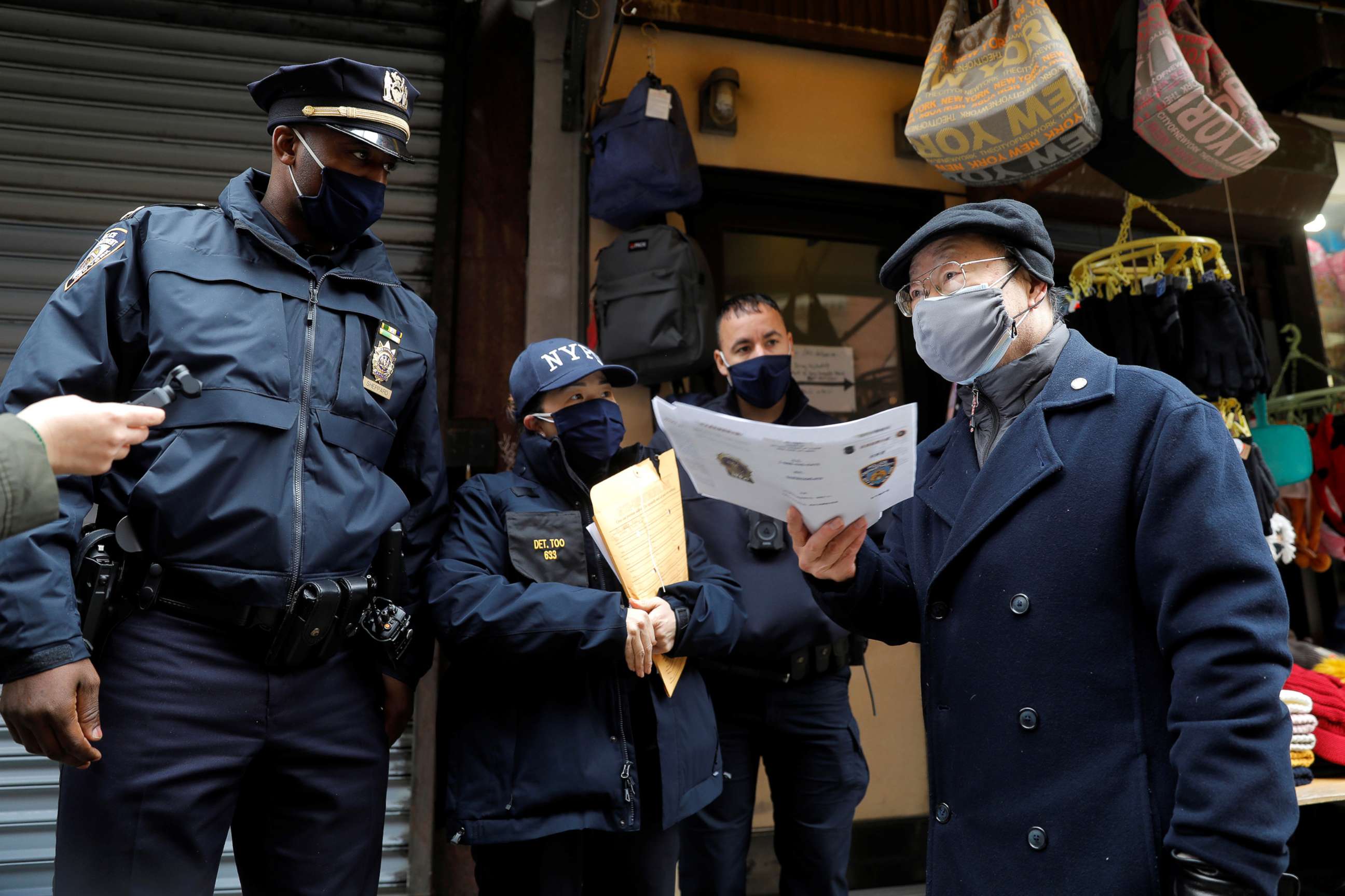 PHOTO: Officers from the New York Police Department Community Affairs Rapid Response Team speak with Justin Yu, president of the Chinese Community Center on Mott Street, in the Chinatown section of Manhattan, March 17, 2021.