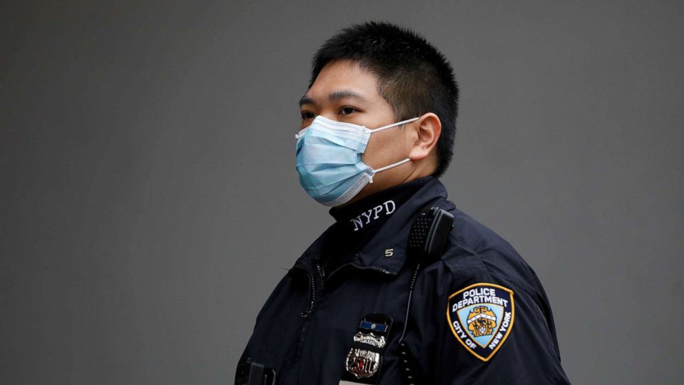 PHOTO: A New York Police Department officer is seen in a protective mask during the coronavirus disease outbreak in the Manhattan borough of New York, March 20, 2020.