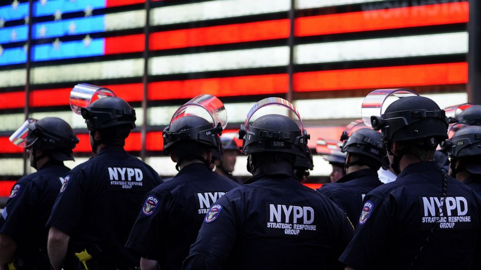 PHOTO: NYPD police officers watch demonstrators in Times Square in New York, June 1, 2020.