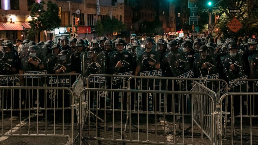 PHOTO: NYPD officers block the exit of the Manhattan Bridge, June 2, 2020, as hundreds protesting police brutality and systemic racism attempt to cross into Manhattan from Brooklyn hours after a citywide curfew went into effect in New York.