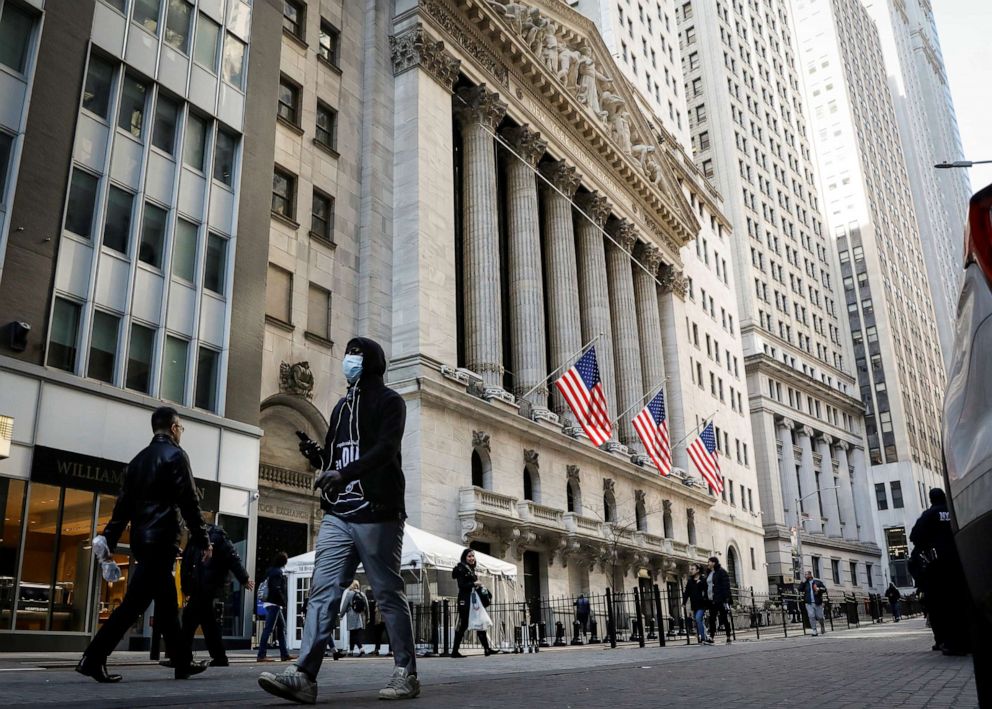 PHOTO: A man wears a mask as he walks near the New York Stock Exchange (NYSE) in the financial district in New York City, U.S., March 2, 2020.