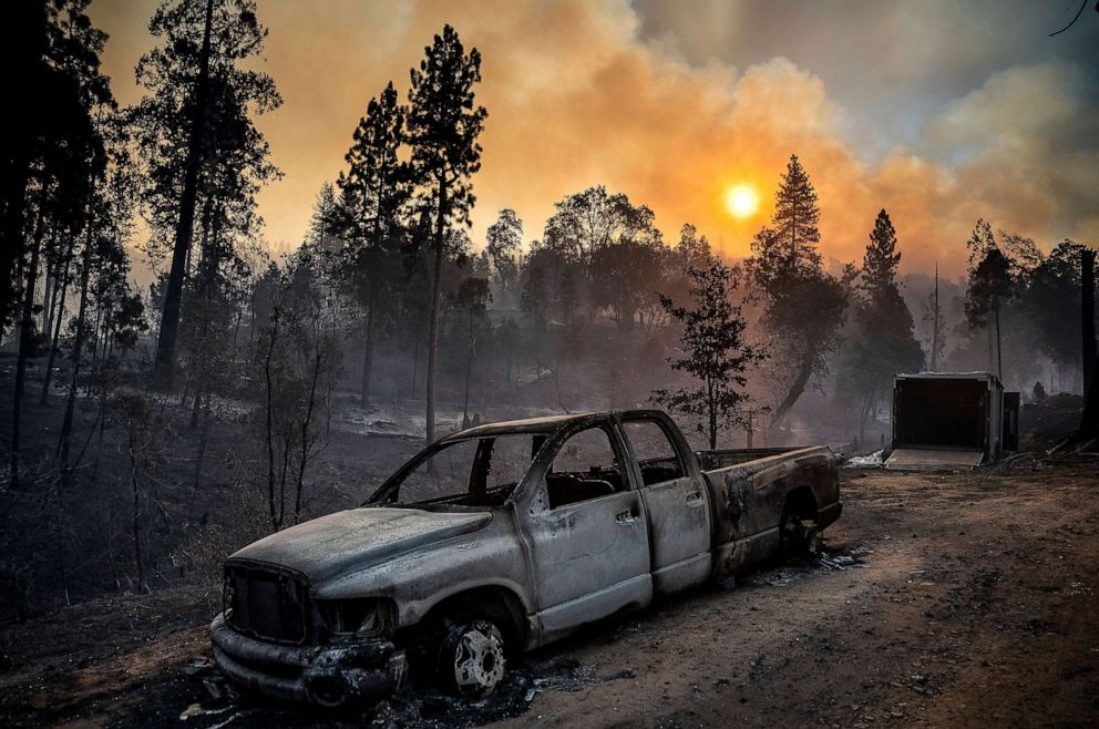 PHOTO: The Oak Fire burns behind a scorched pickup truck in the Jerseydale community of Mariposa County, Calif., July 24, 2022.
