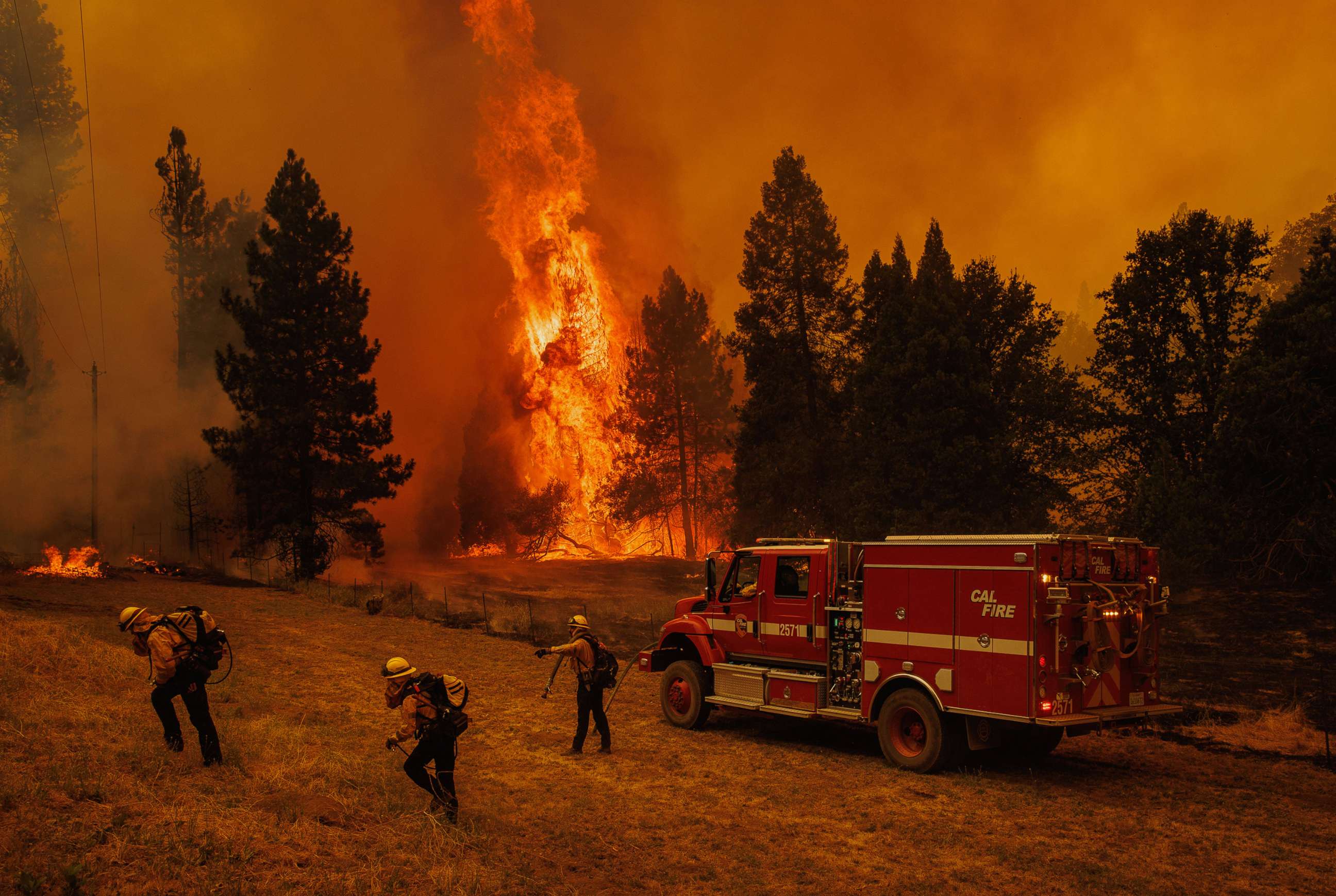 PHOTO: Firefighters work to defend a structure as flames from the Oak Fire approach in unincorporated Mariposa County, Calif., July 23, 2022.