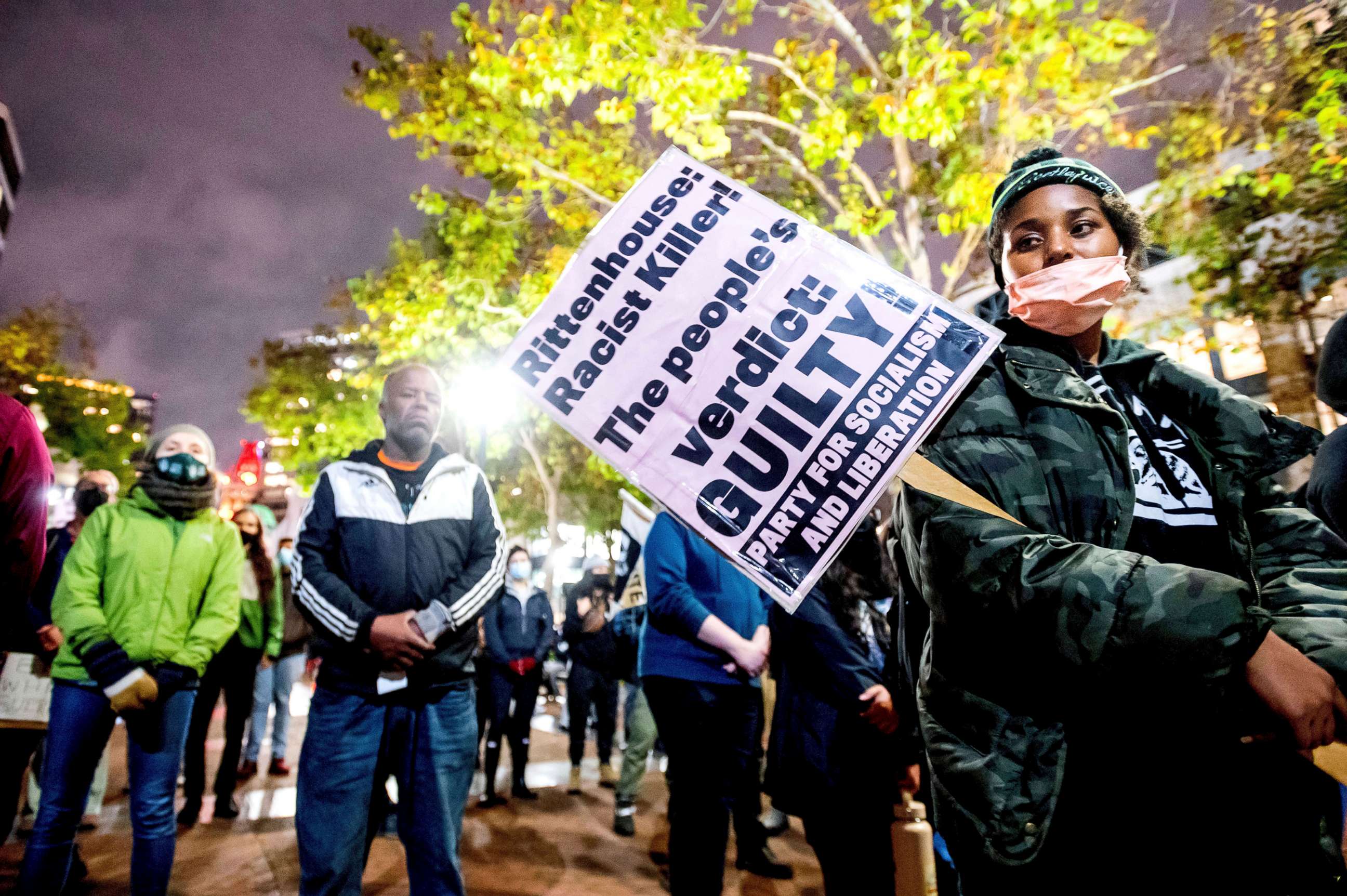PHOTO: Bria Swenson holds a sign during a demonstration, Nov. 19, 2021, in Oakland, Calif., following the acquittal of Kyle Rittenhouse in Kenosha, Wis.