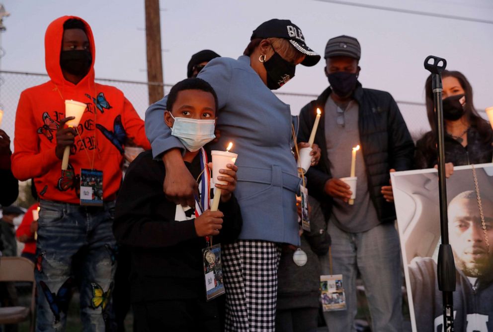 PHOTO: Sylvia Lewis, center, hugs her grandson Rozay, 9, Rajuan Lewis, 7, left, during a vigil and anti-violence rally for her son Reuben Lewis at Concordia Park in Oakland, Calif., on Sunday, Feb. 28, 2021.