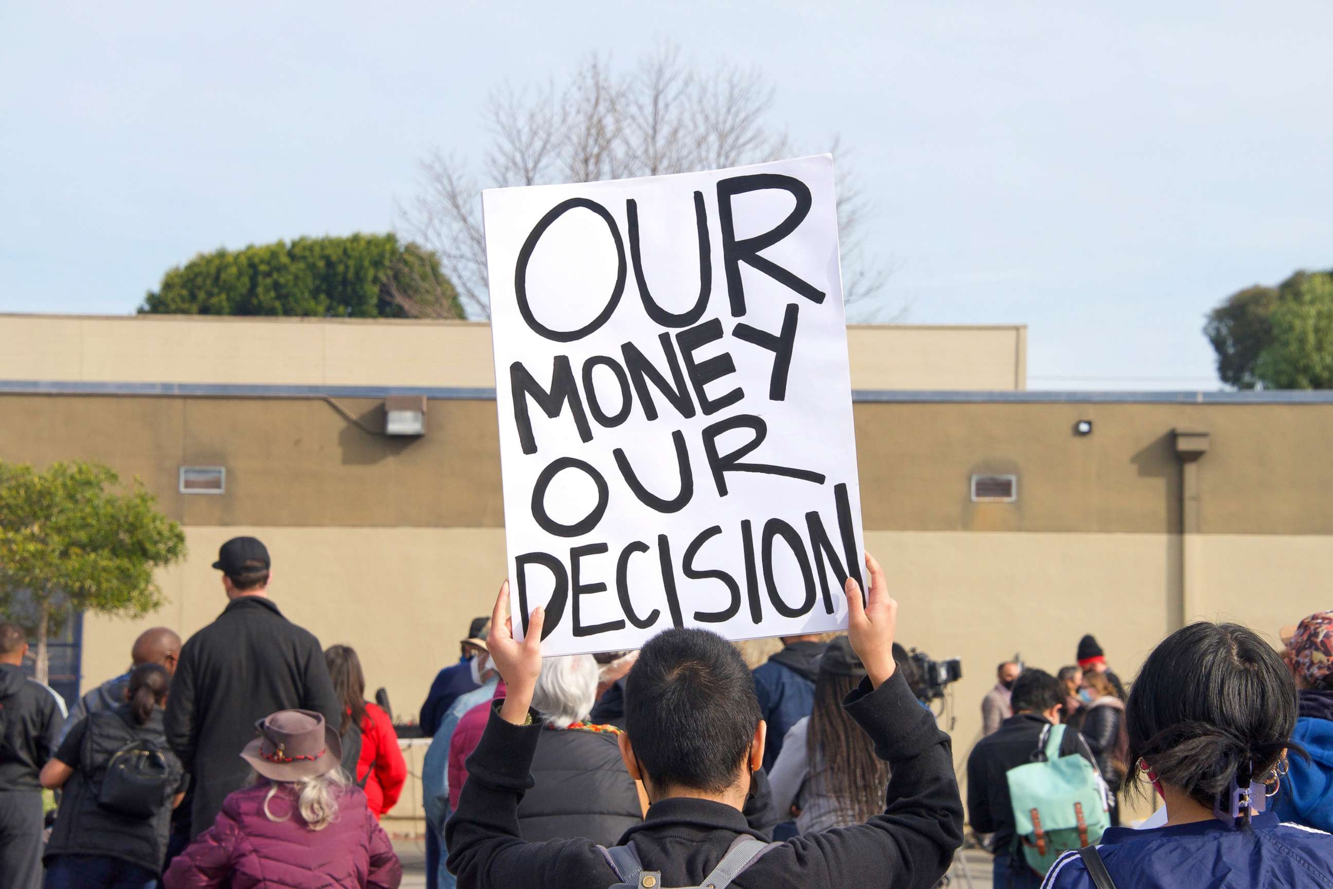 PHOTO: Protesters hold signs protesting planned school closures in the district at Prescott Elementary school in Oakland, Calif., Feb. 5, 2022.