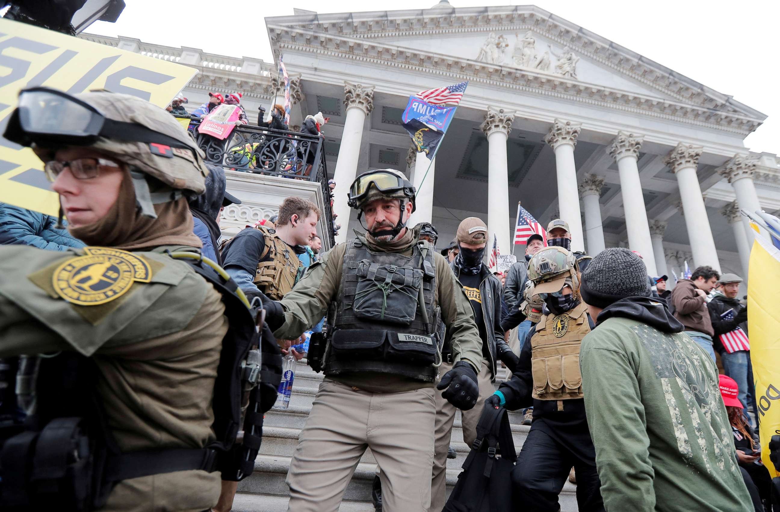 PHOTO: Jessica Marie Watkins (l) and Donovan Ray Crowl (c), both from Ohio, march down the East front steps of the Capitol with the Oath Keepers militia group among supporters of President Donald Trump protesting in Washington, Jan. 6, 2021.