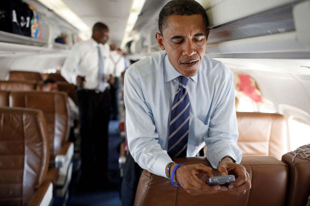 PHOTO: The presidential candidate, Senator Barack Obama, is using his mobile phone in his campaign plane at Reagan National Airport on July 9, 2008 in Washington, DC.