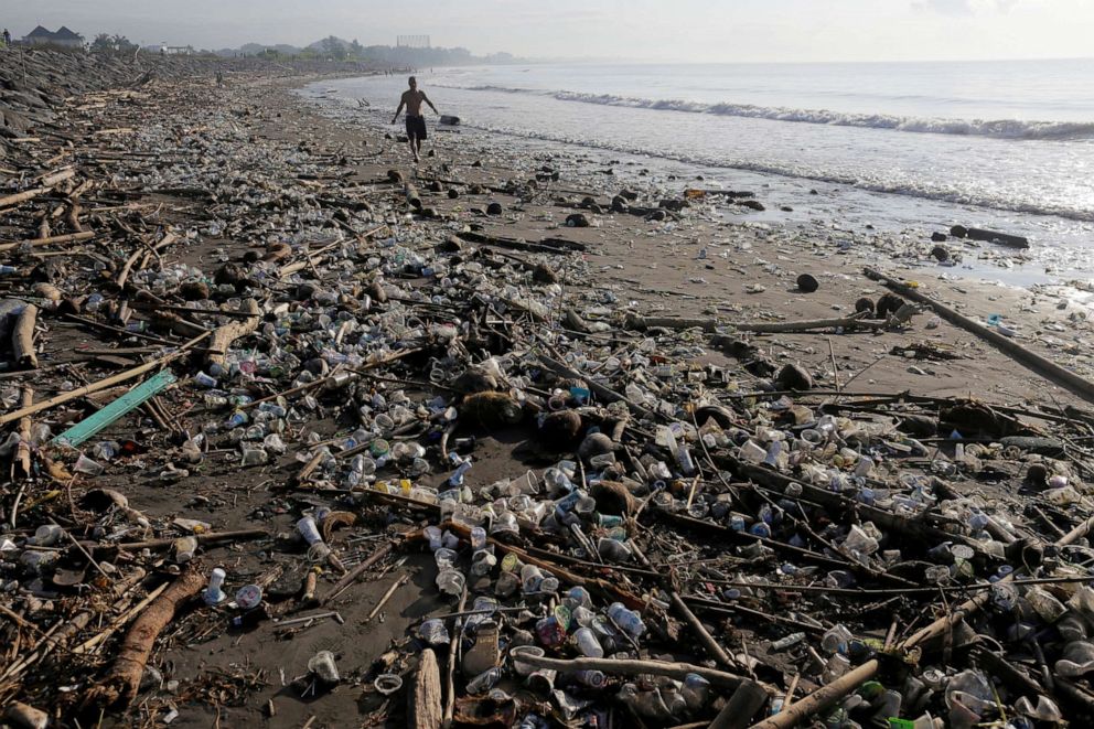 PHOTO: A local resident walks along a section of Matahari Terbit beach covered in plastic and other debris washed ashore by seasonal winds near Sanur, Bali, Indonesia, April 11, 2018.