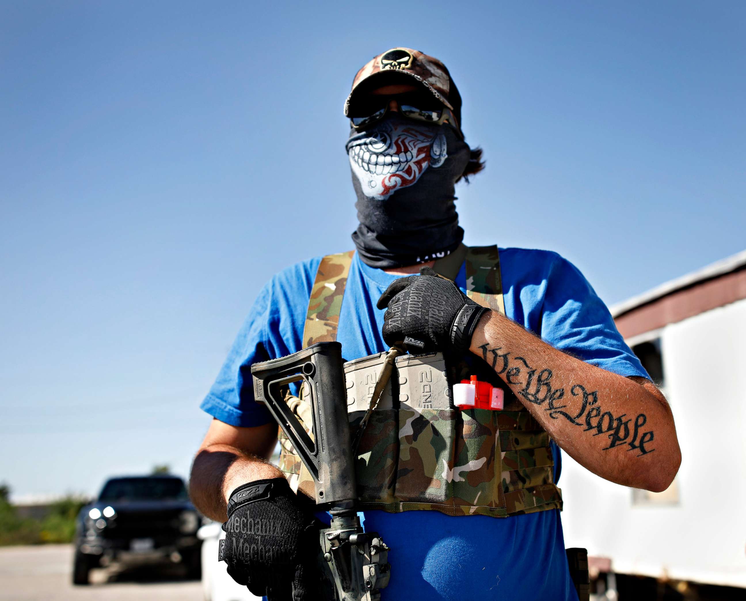 PHOTO: Armed protester Wyatt Winn waits for Ector County Sheriff's officers and Texas State Troopers, who were monitoring a protest, shortly before his arrest Monday, May 4, 2020, at Big Daddy Zane's bar near Odessa, Texas. 