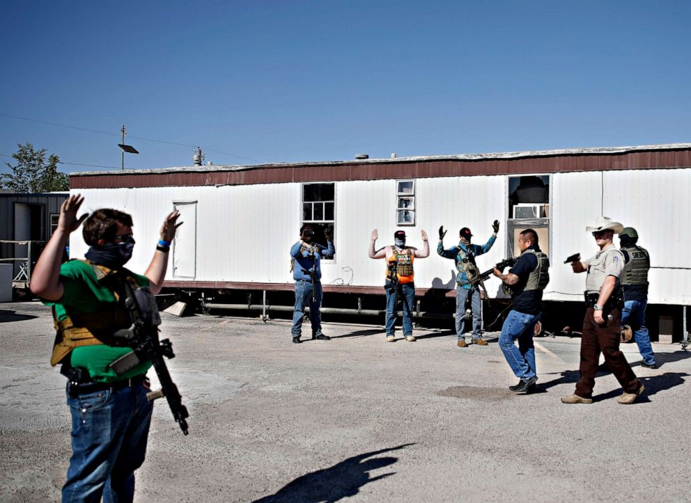 PHOTO: Deputies of the Ector County Sheriff's Office advance on protesters who gathered outside Big Daddy Zane's bar, May 4, 2020, in Odessa, Texas. 