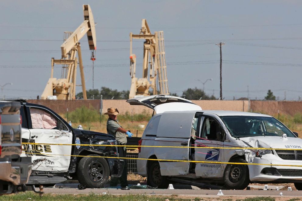 PHOTO: Law enforcement officials process the crime scene from a shooting rampage which ended with the shooter being shot dead by police in a stolen mail van, right, in Odessa, Texas, Sept. 1, 2019.