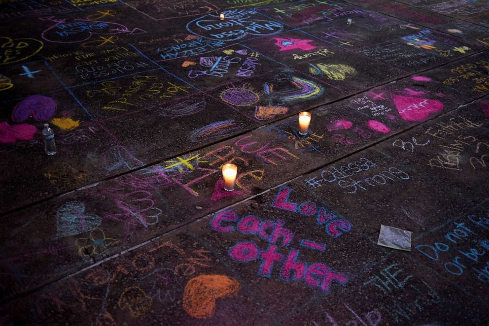 PHOTO: Messages written in sidewalk chalk are seen as people gather for a vigil following Saturday's shooting in Odessa, Texas, on Sept. 1, 2019.