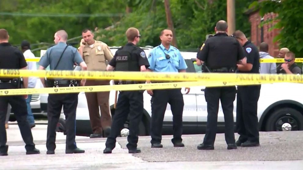 PHOTO: Law enforcement officers congregate at the scene in Wellston, Mo., where  North County Police Cooperative Police Officer Michael Langsdorf was shot and killed, June 24, 2019. 