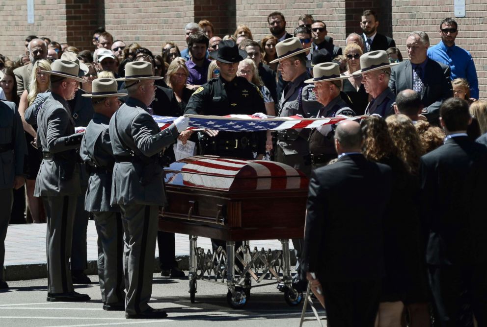 PHOTO: The honor guard lifts the flag off of Trooper Nicholas Clark's casket, which was folded and presented to Clark's family during the funeral service for Clark,  July 8, 2018 at Alfred University in Alfred, N.Y