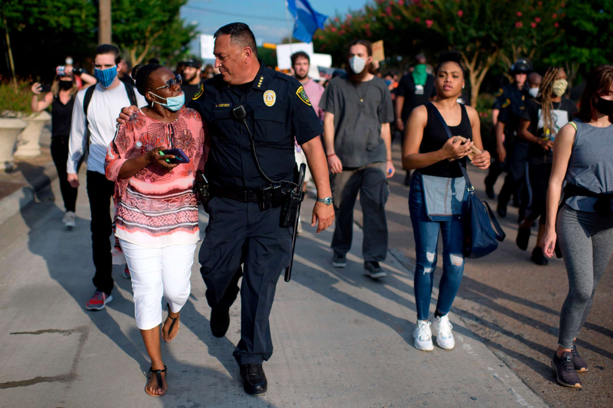 PHOTO: Houston Police Chief Art Acevedo walks arm-in-arm with a woman during a "Justice for George Floyd" event in Houston, Texas, May 30, 2020, after George Floyd died while being arrested and pinned to the ground by a Minneapolis police officer.