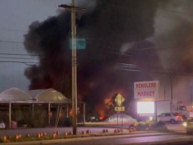 Small plane crashes at car dealership