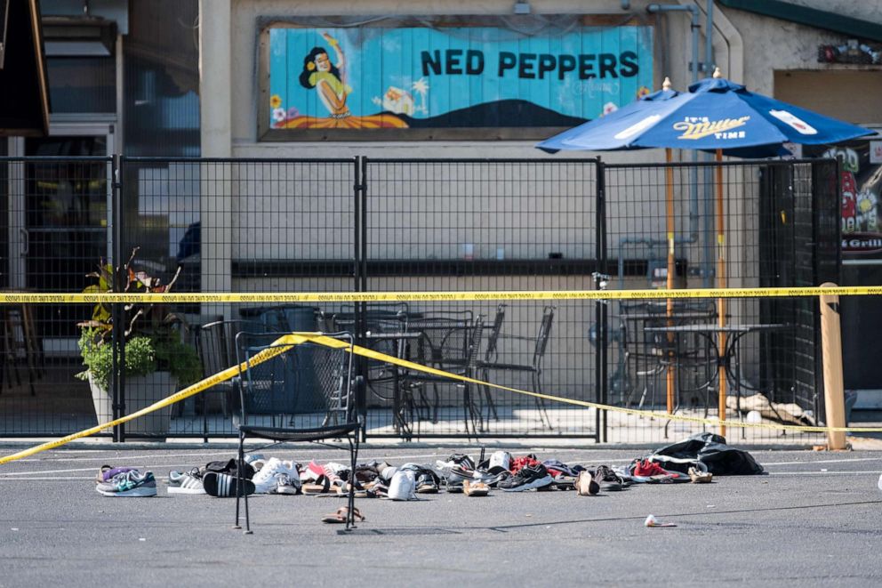 PHOTO: Pairs of shoes are piled behind the Ned Peppers bar belonging to victims of an active shooting that took place in Dayton, Ohio, Aug. 4, 2019.