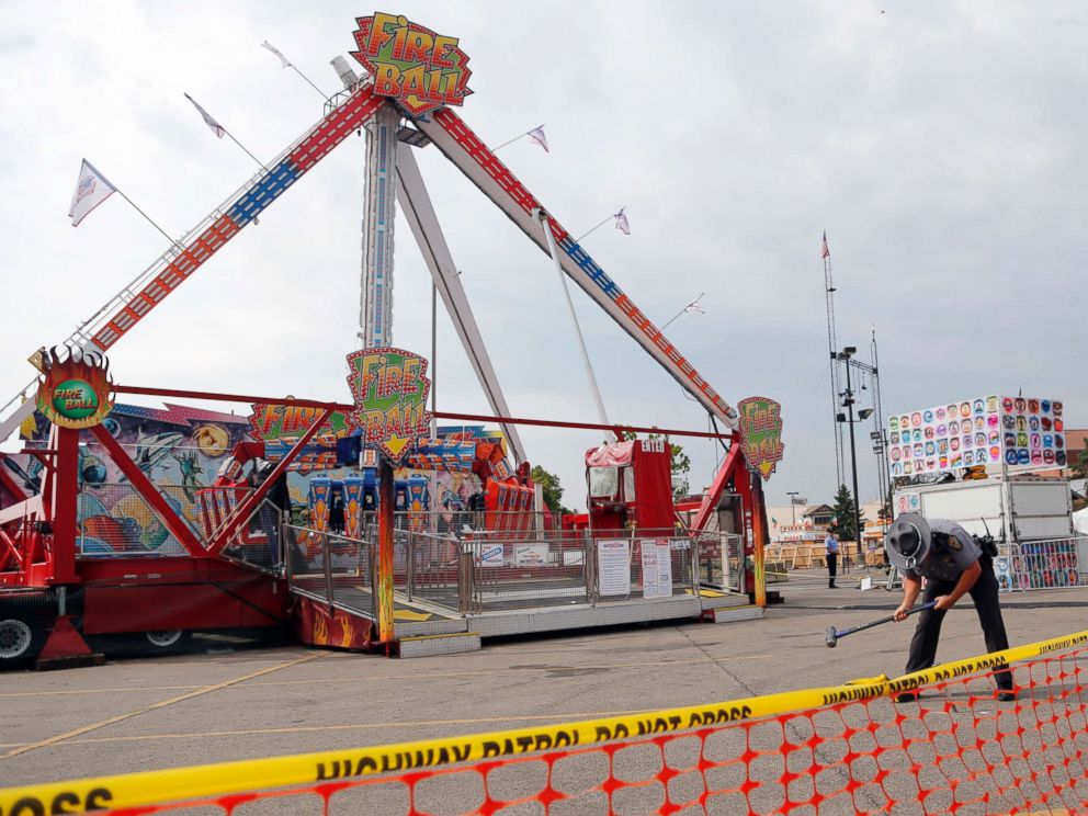 PHOTO: An Ohio State Highway Patrol trooper removes a ground spike from in front of the fire ball ride at the Ohio State Fair Thursday, July 27, 2017, in Columbus, Ohio.