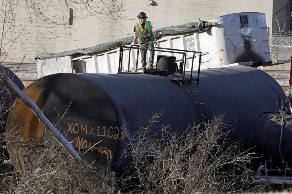 PHOTO: FILE - A cleanup worker stands on a derailed tank car of a Norfolk Southern freight train in East Palestine, Ohio, continues, Feb. 15, 2023.