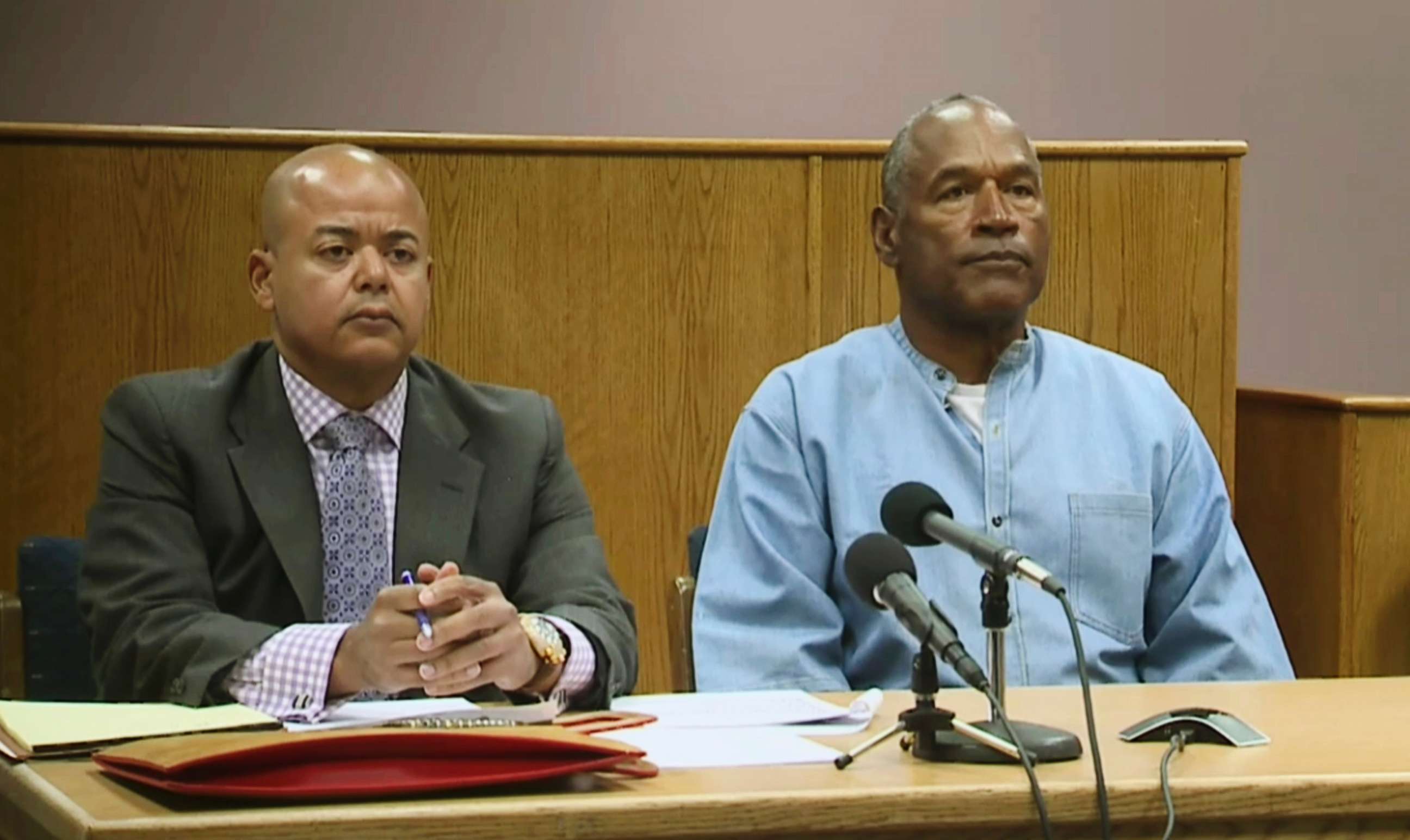 PHOTO: Former NFL football star O.J. Simpson appears with his attorney, Malcolm LaVergne, left, via video for his parole hearing at the Lovelock Correctional Center in Lovelock, Nev., on July 20, 2017.